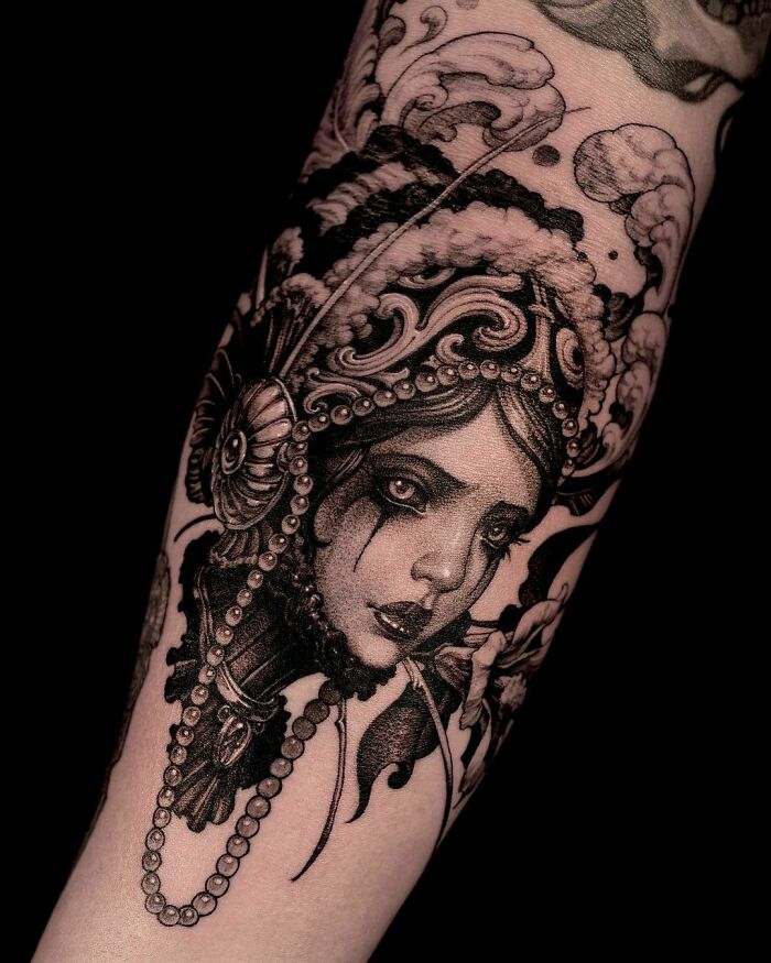 girl witha large headpiece and black tears large tattoo