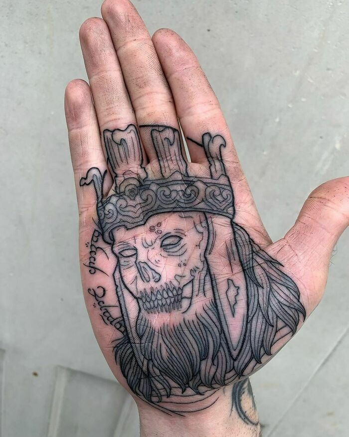 Lord of the Rings tattoo depicting a skeletal king with a crown inked on a person's palm.