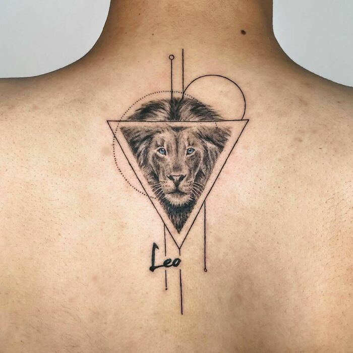 Geometric Leo tattoo with a lion's face, combining sharp lines and circles on a person's back.
