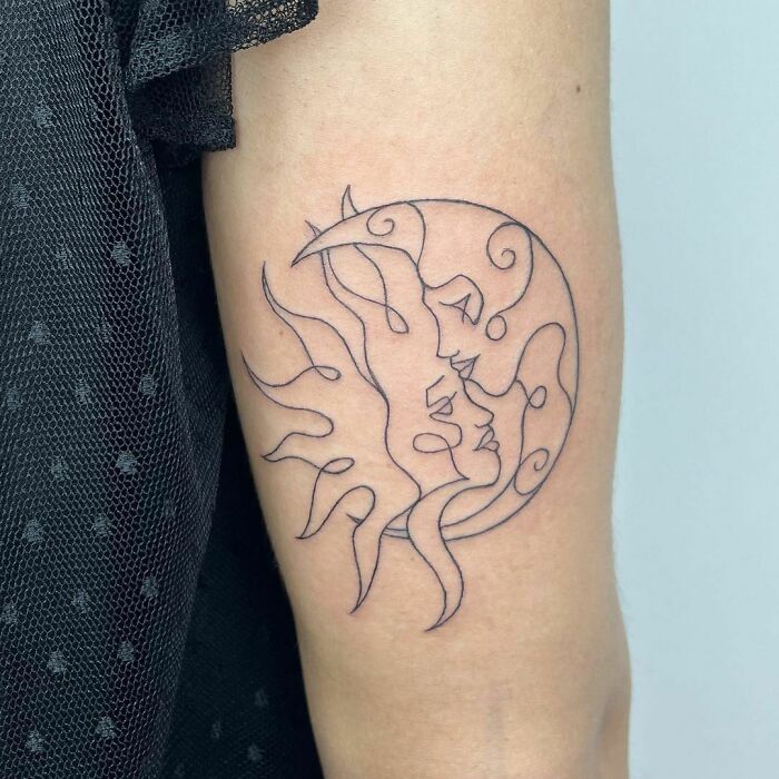 Sun and moon forming yin yang tattoo