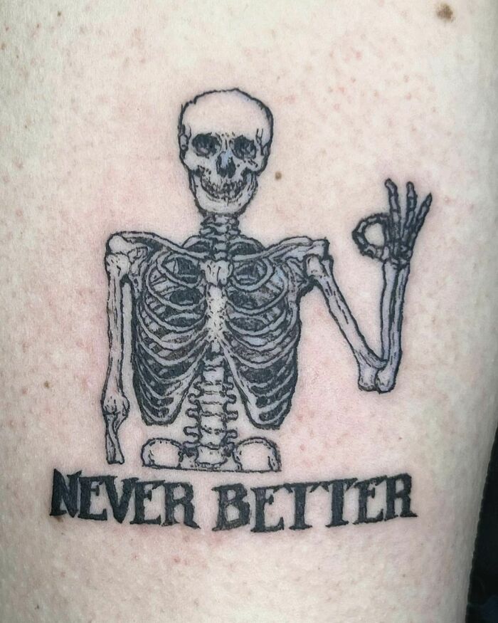 Skeleton that shows Okay sign tattoo