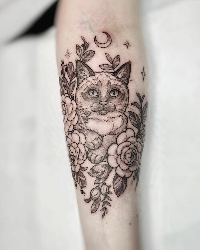 Siamese cat with flowers and moon forearm tattoo