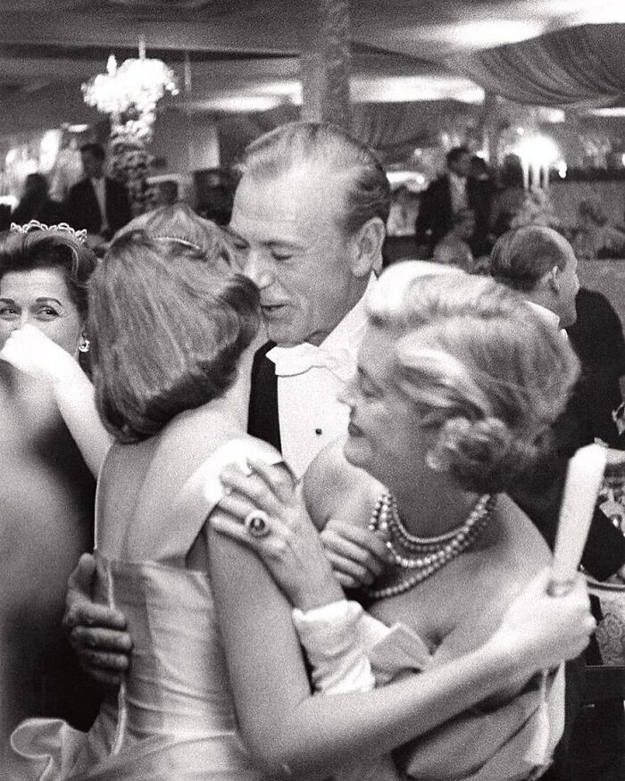 Gary Cooper Hugging His Daughter Maria And His Wife Veronica At A New Year's Party Held At Romanoff's In Beverly Hills, California, 1957. Photo By Slim Aarons