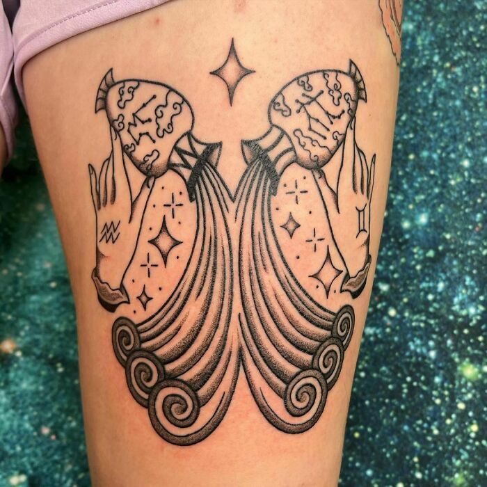 Symmetrical zodiac tattoo featuring stars and swirling patterns on a person's leg.