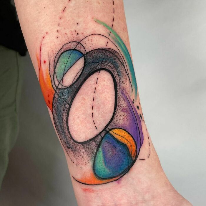 Abstract and colorful arm Tattoo