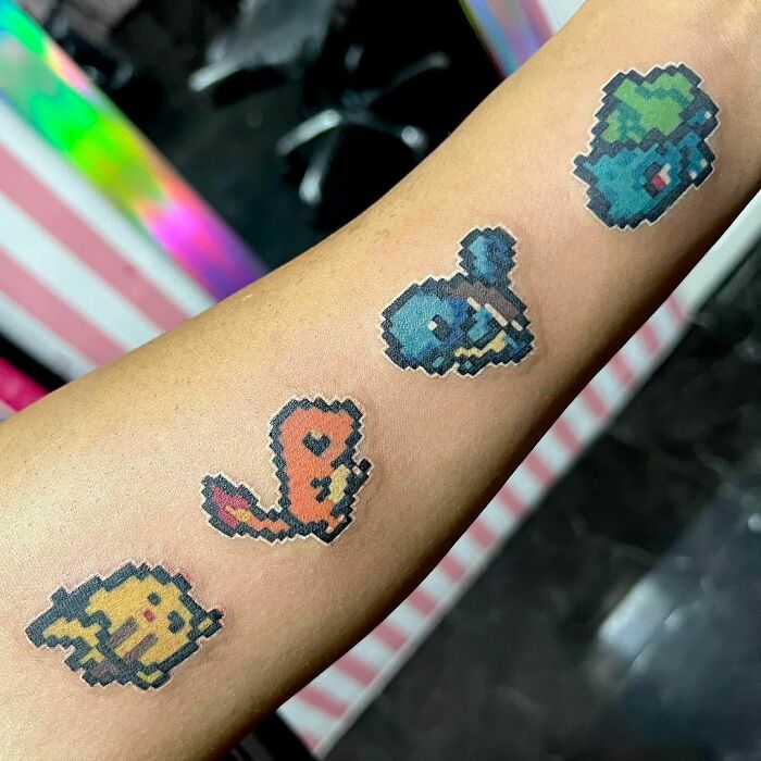 Pikachu, Charmander, Squirtle and Bulbasaur arm tattoo 