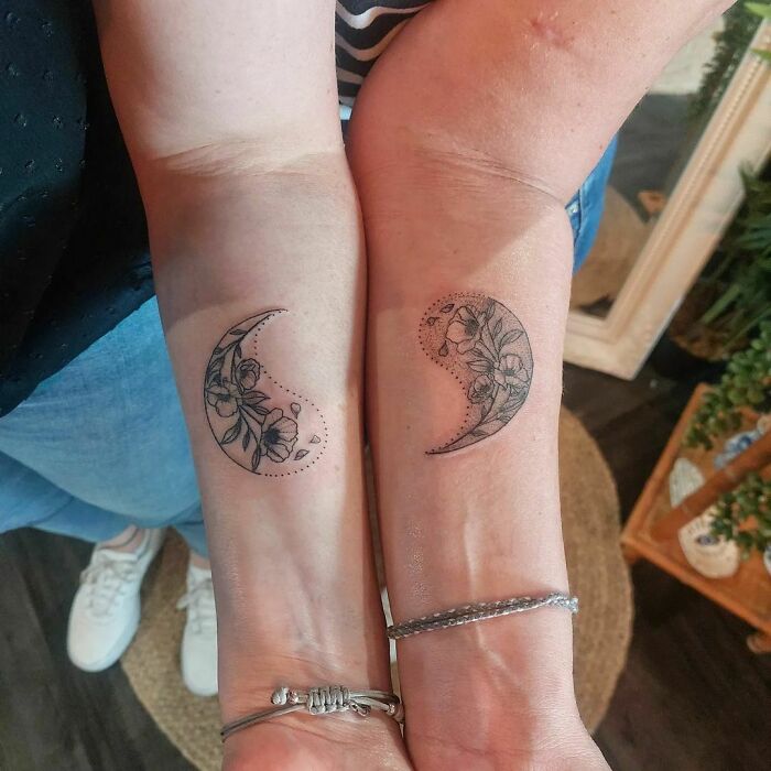 Two pieces of yin yang symbol with flowers on arms tattoo