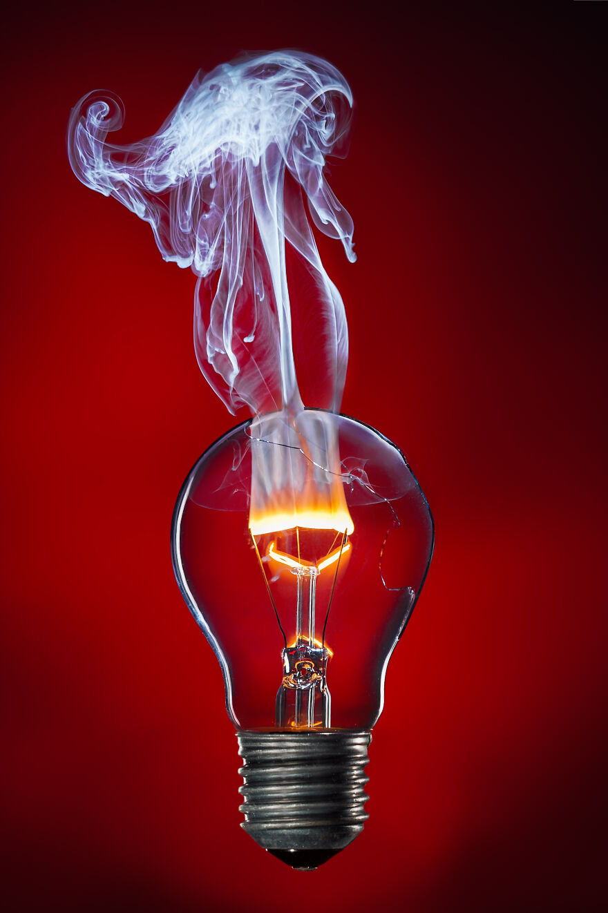 The Tungsten Filament Burning With A Flame In The Light Bulb By Stefan Krause