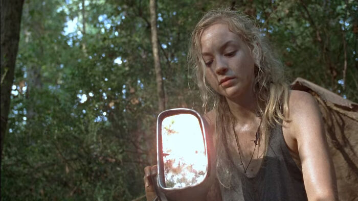 Beth Greene holding car mirror