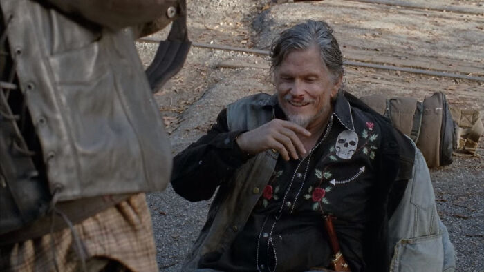 Joe holding fingers on chin on his knees