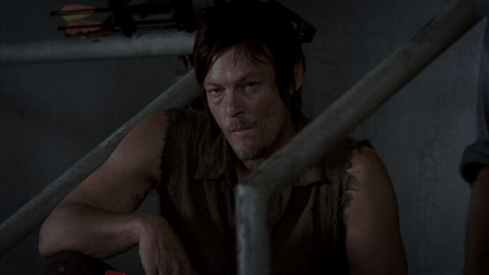 Daryl Dixon siting on stairs