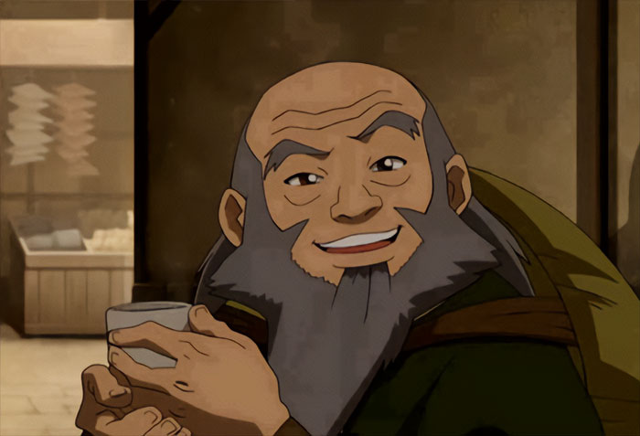 Uncle Iroh smiling and holding tea