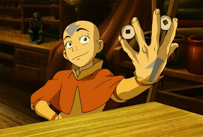 Aang holding coins