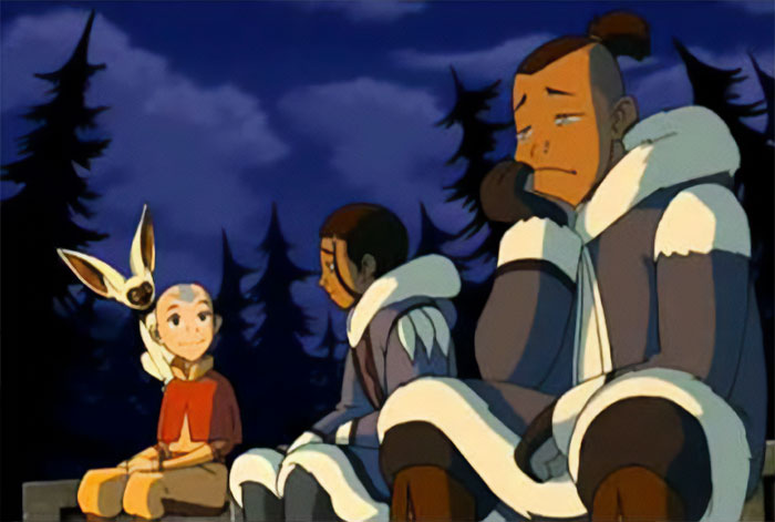 Aang sitting with Momo, Katara and Sokka