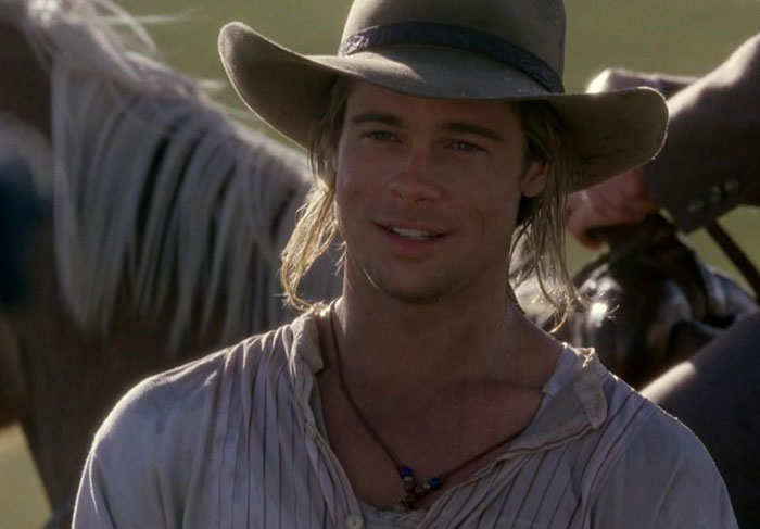 Actor in a vintage setting, wearing a cowboy hat and light shirt, standing outdoors. Actor in a vintage setting, wearing a cowboy hat and light shirt, standing outdoors.