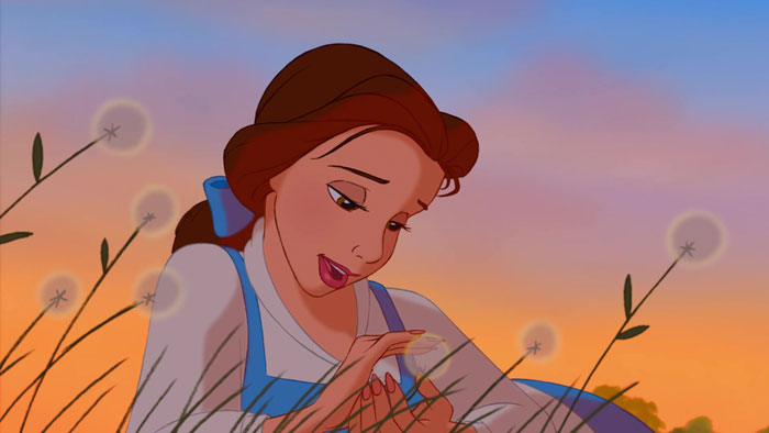 Belle singing and holding a dandelion 