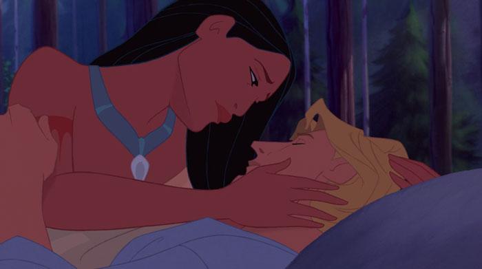 Pocahontas looking sad while holding John Smith's face