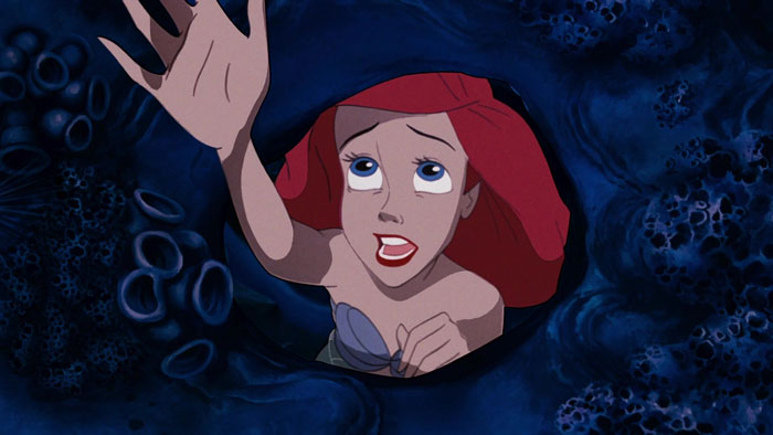 Ariel reaching out her hand in the depths of the sea