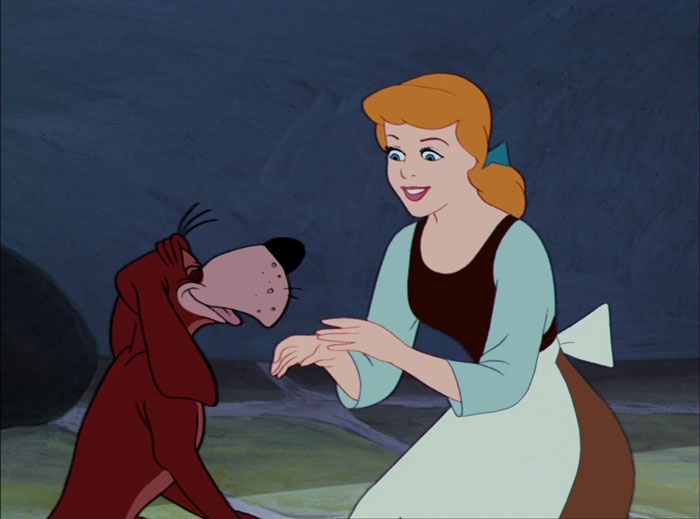Cinderella smiling and looking at a dog 