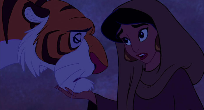 Jasmine looking sad and touching the face of her pet tiger Rajah 