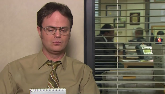 Dwight Schrute looking hesitantly at his notes