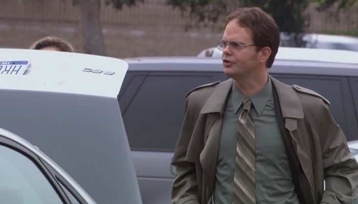 Dwight Schrute telling something to other people very passionately 