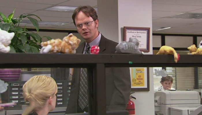 Dwight Schrute talking to Angela with a slightly worried expression
