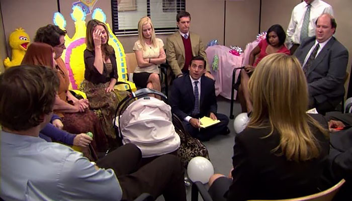 the office cast surrounding a baby stroller