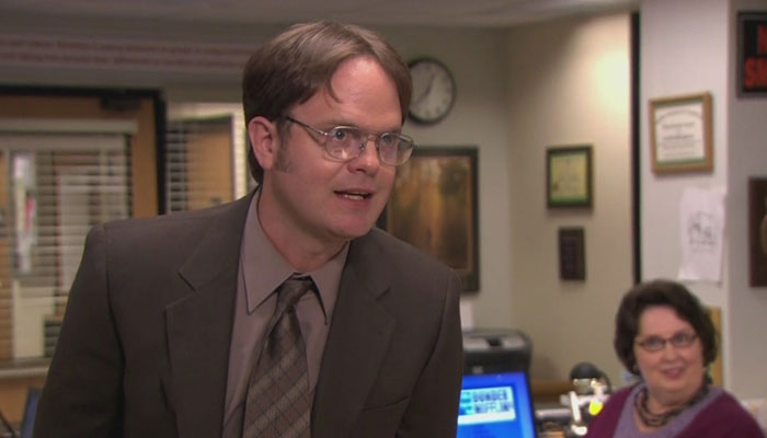 Dwight Schrute talking with an annoyed expression
