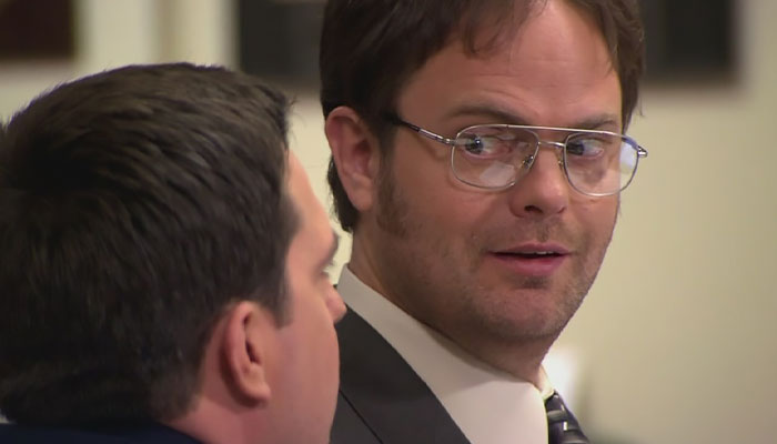 Dwight Schrute looking at Andy Bernard with a playful yet scary side-eye
