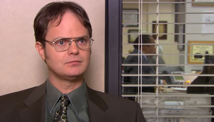Dwight Schrute looking with a waiting look in the interview room