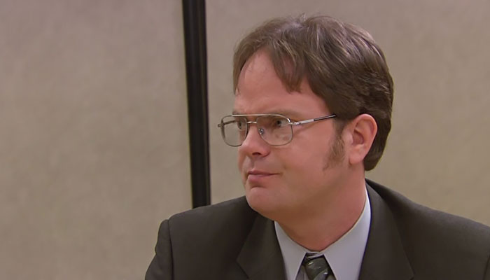 Dwight Schrute looking with a slightly annoyed face at someone