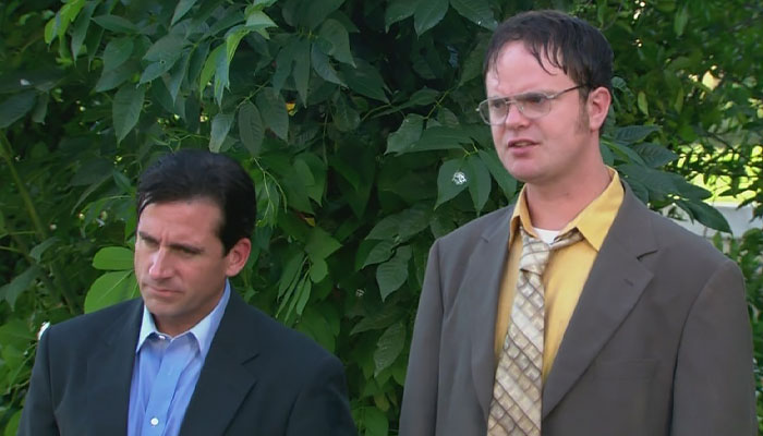 Micheal Scott and Dwight Schrute standing outside while being wet
