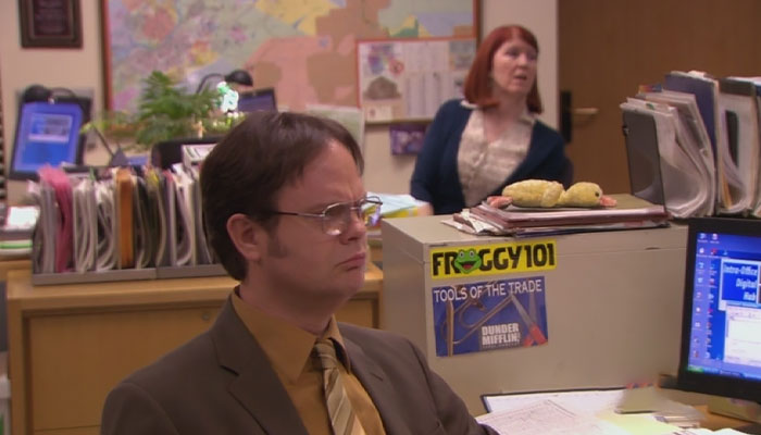 Dwight Schrute looking at something with a soured expression