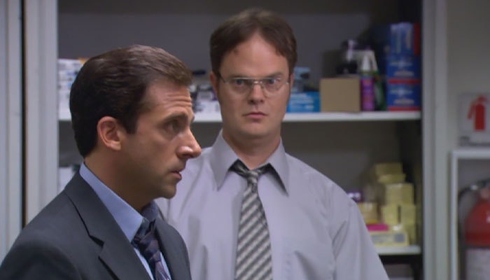 Dwight Schrute is looking at Michael Scott with a slight look of surprise