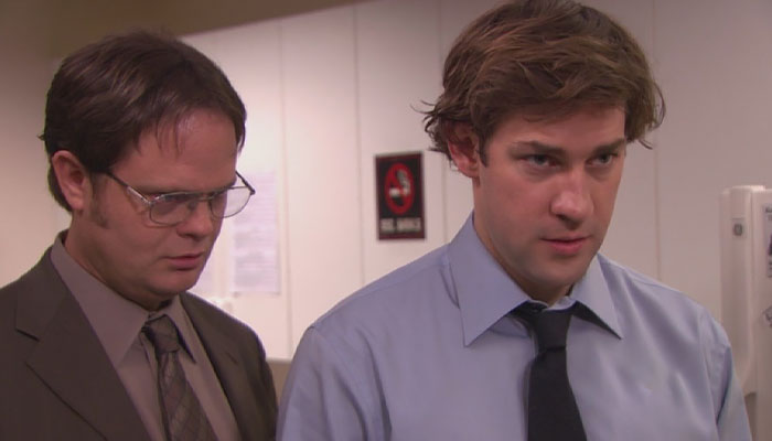 Dwight Schrute looking menacingly from over Jim's shoulder