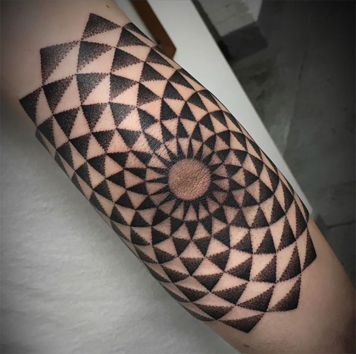 Ornamental mandala elbow tattoo