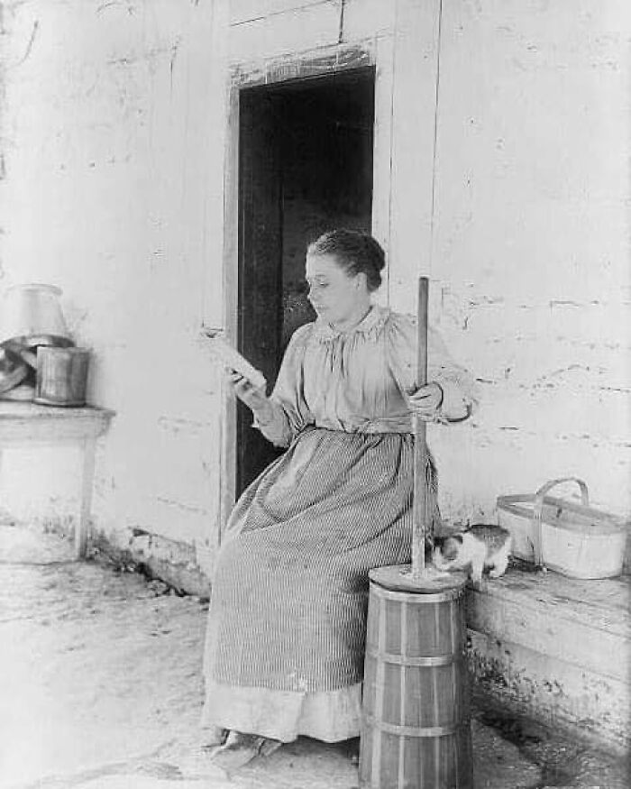 A Woman Churning Milk To Butter While Reading A Book, 1897
