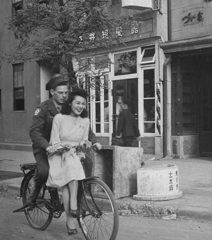 Us Soldier Giving A Japanese Girl A Bicycle Ride. Japan, 1946