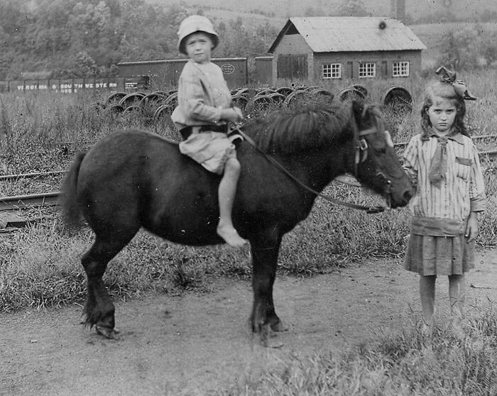 Photo Of Two Children And A Pony With Railroad Shop In Background. Western North Carolina, 1930's