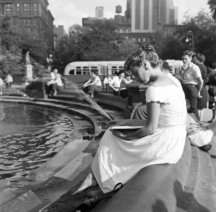 A Woman Reads A Book Next To The Washington Square Park Fountain In The Late 1940s