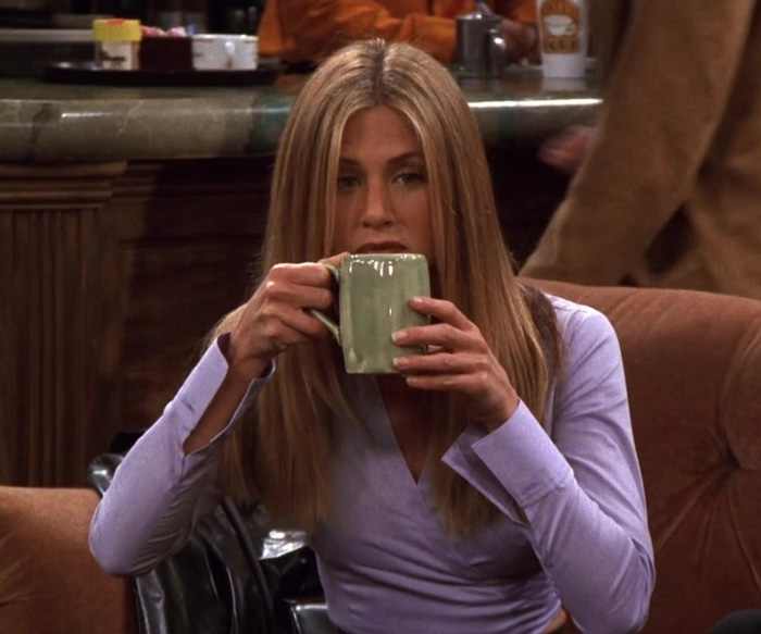 Rachel is drinking coffee from green mug 
