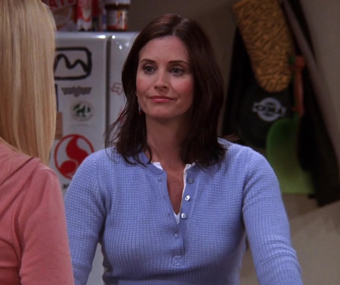 Monica wearing blue sweater 