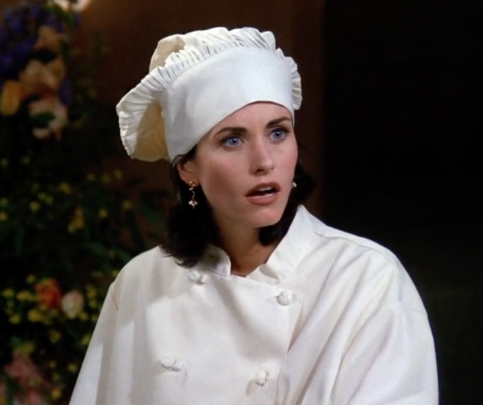 Monica wearing chef outfit 