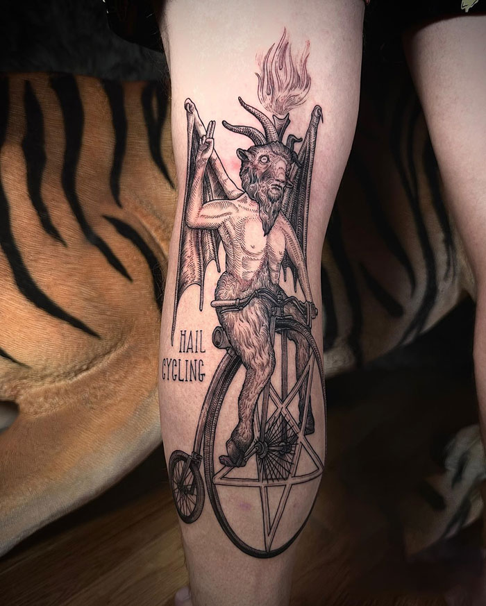 Satan on a unicycle with "hail cycling" written next to it tattoo