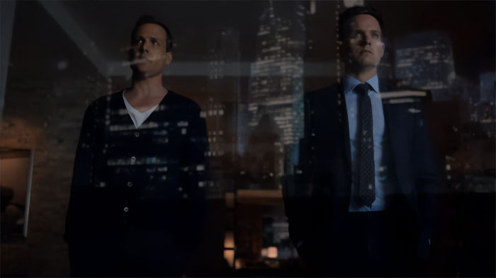 Harvey Specter looking through the panoramic window