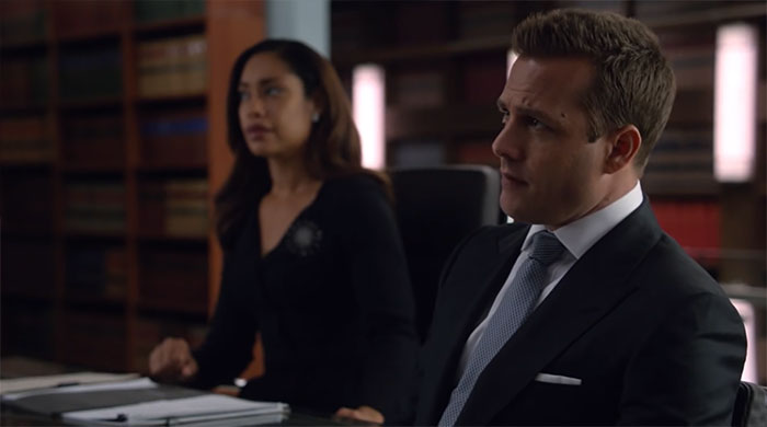 Harvey Specter sitting in meeting room