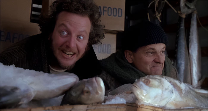 Harry and Marv sitting next fish from Home Alone