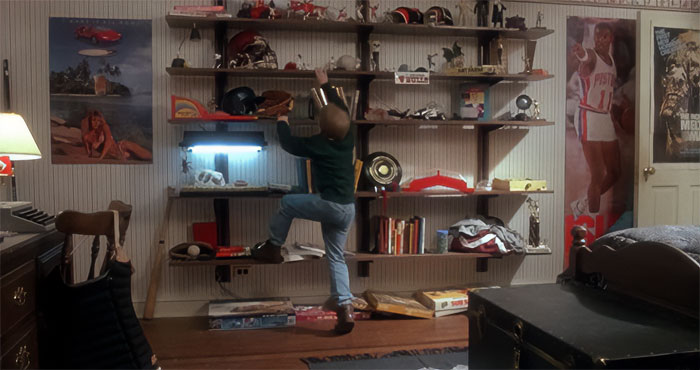 Kevin McCallister climbing on bookshelf from Home Alone