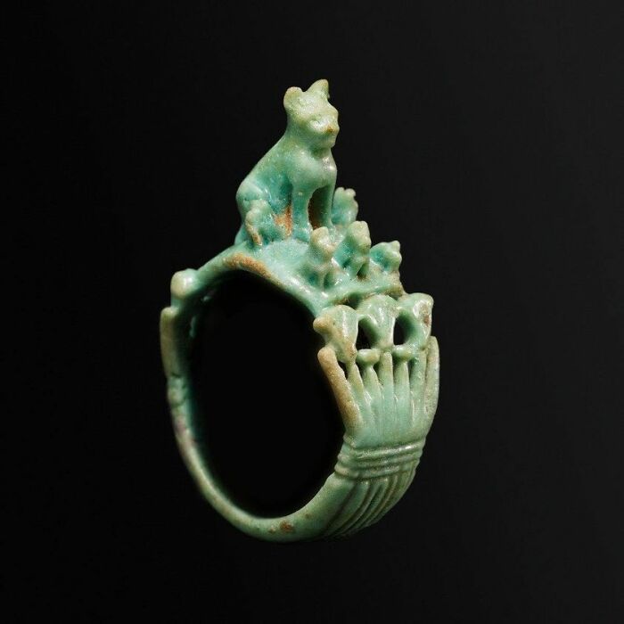 An Ancient Egyptian Faience Ring Depicting A Mother Cat With Kittens Would Have Been A Charming And Significant Artifact In The Context Of Ancient Egyptian Culture